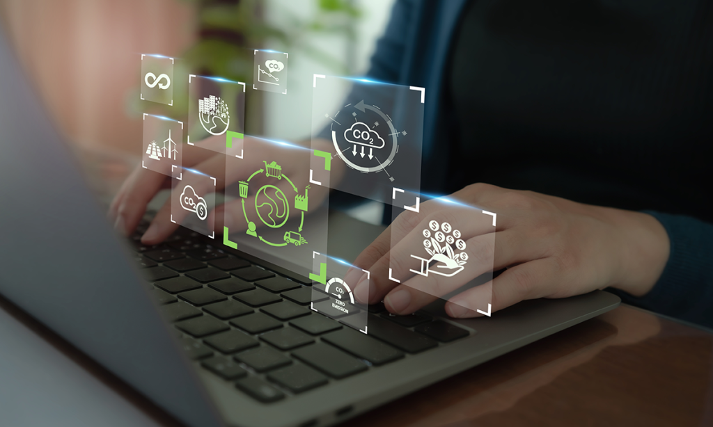 A person types on a laptop with digital icons and graphics floating above the keyboard, representing technology and innovation.