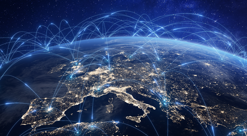 A nighttime view of Europe from space, illuminated with lights and connected by glowing lines, symbolizing global communication and connectivity.