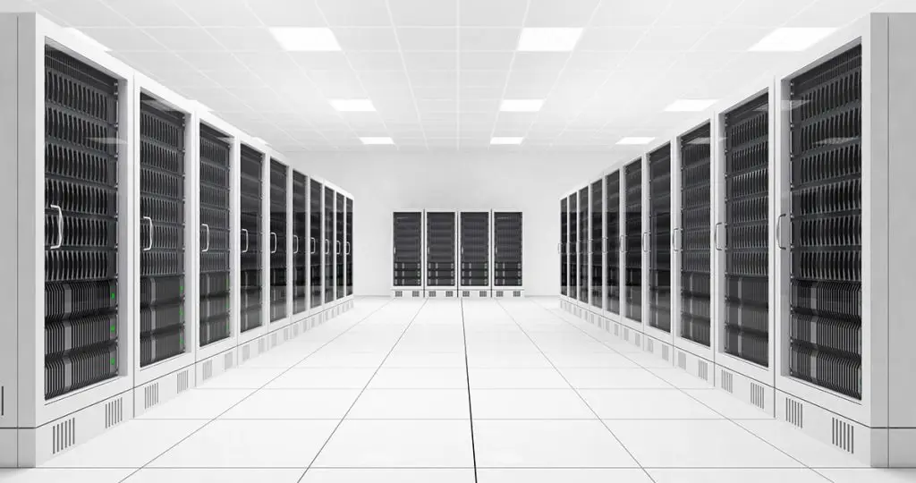 An expansive, sterile room lined with rows of server racks, illuminated by bright overhead lights, emphasizing a high-tech environment.