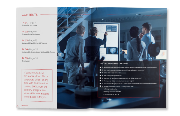 A group of professionals discussing data on screens while reviewing important documents in a modern office setting.