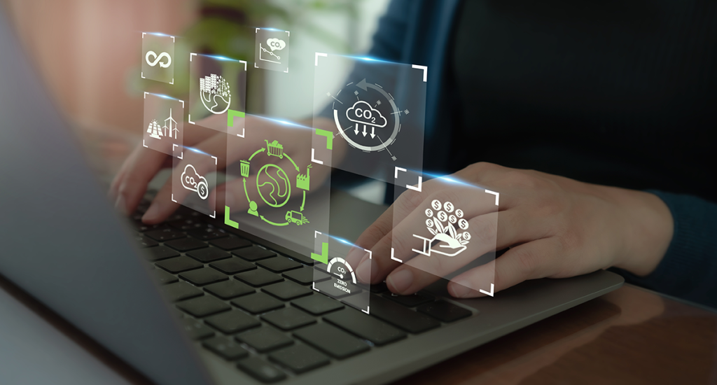 A person types on a laptop with digital icons and graphics floating above the keyboard, representing technology and innovation.